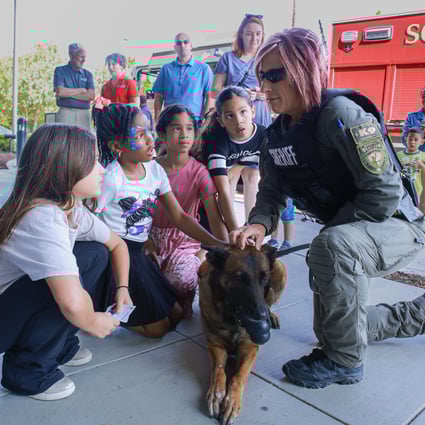 Officer Kelly and K-9 Officer Ita conversing with kids in attendance